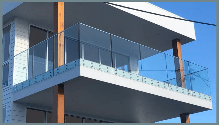 modern home with glass balustrade allowing natural light into upper balcony