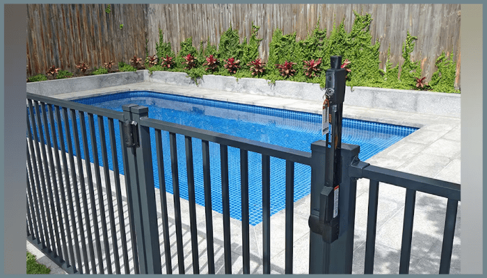 Black aluminium pool fence gate with a child-safe self-closing latch, installed to meet Australian pool safety compliance standards.