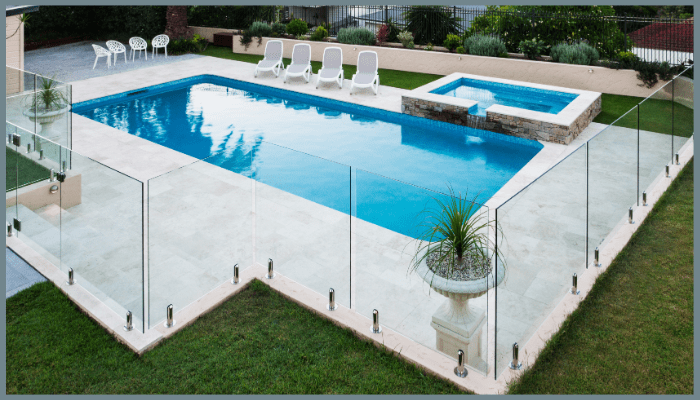 Sleek Griffith backyard pool with frameless glass pool fencing and landscaped garden.