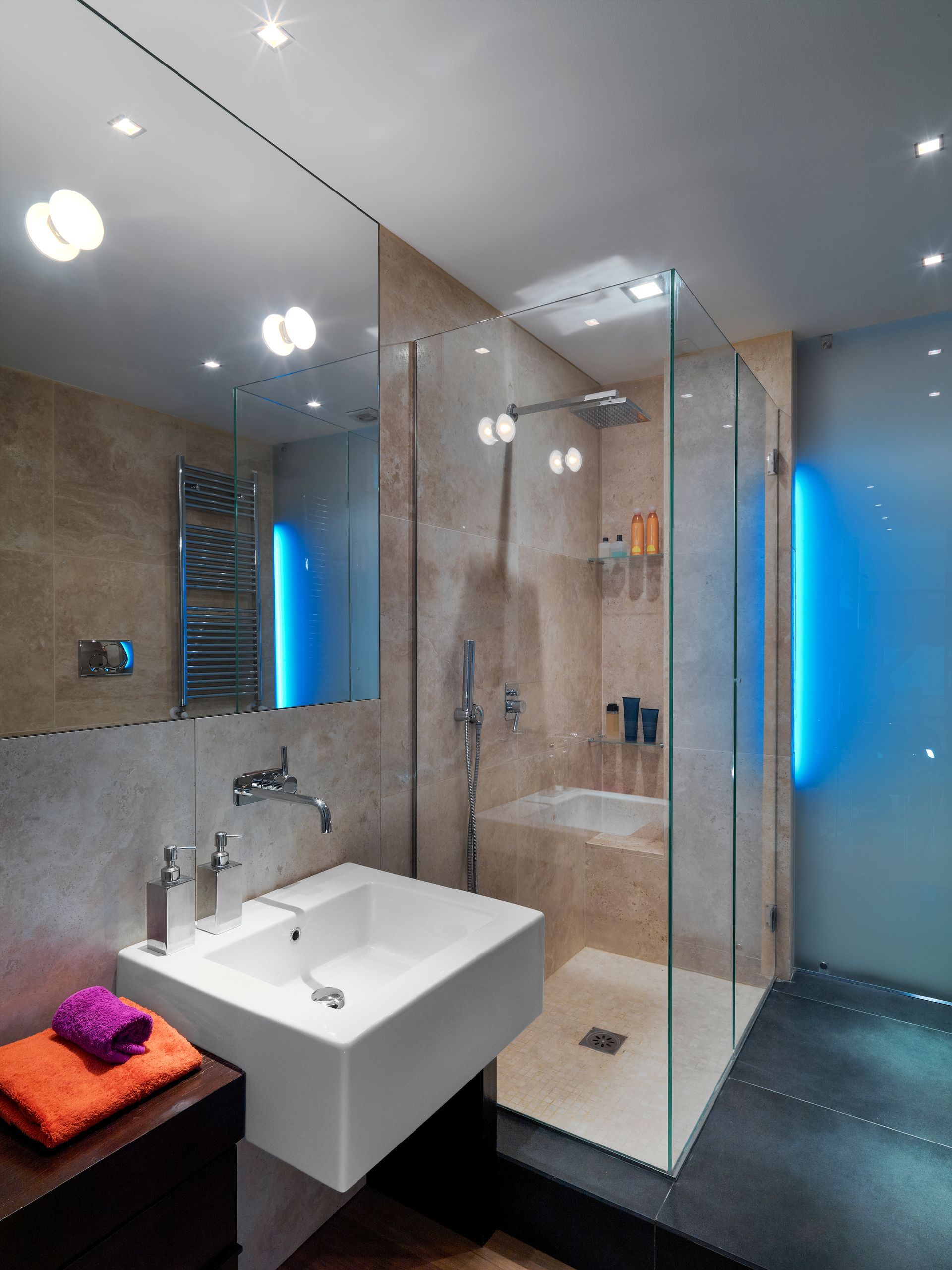 A bathroom with a sink and a walk in shower