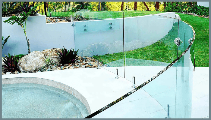 Curved frameless glass pool fencing with certified safety glass and stainless steel fittings for durability