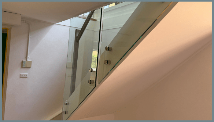 Interior staircase with standoff glass balustrade and stainless steel mounts