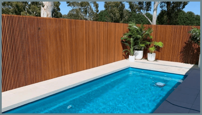Timber screening providing privacy and a natural look for a backyard pool in Canberra.