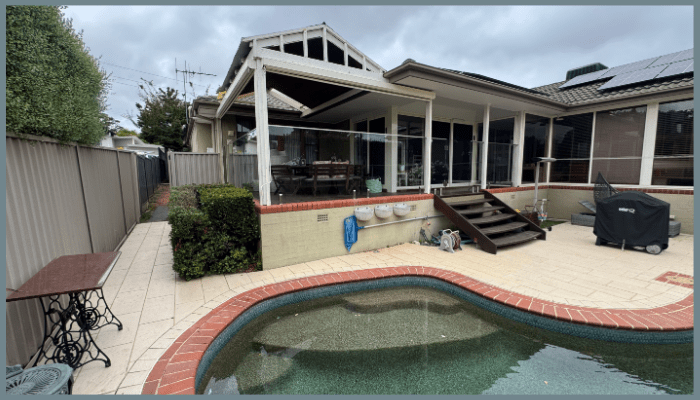 Weather-resistant glass balustrade installed on an elevated balcony overlooking a backyard pool in Canberra, highlighting durability and low maintenance.