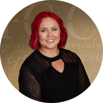 Woman with bright red hair smiles, wearing a black top. Background with text.