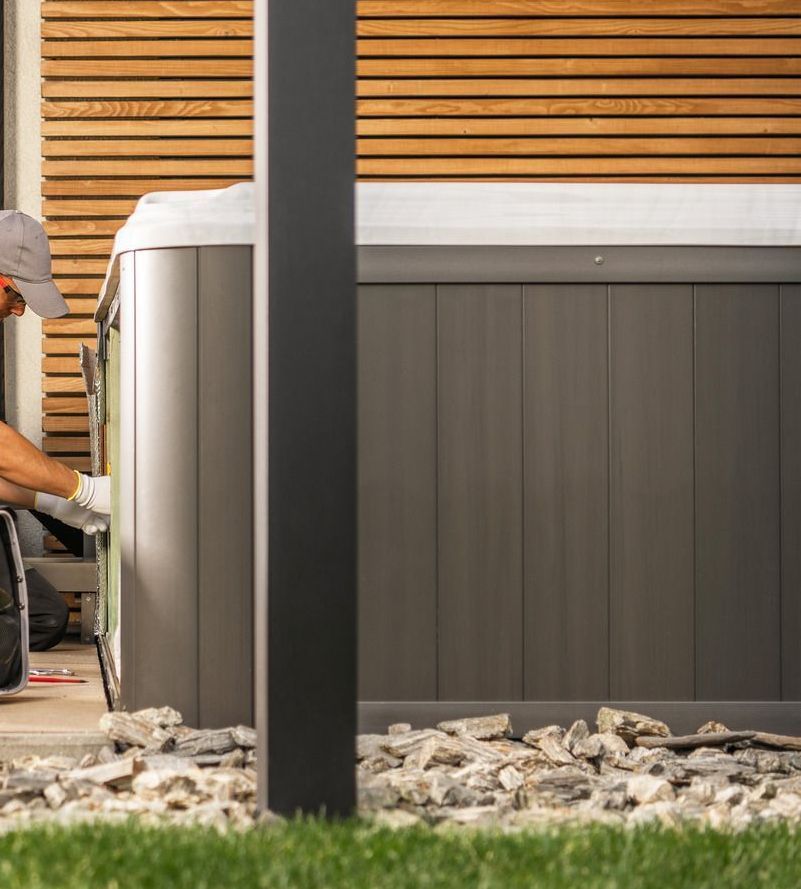 A man is working on an electrical box with a multimeter