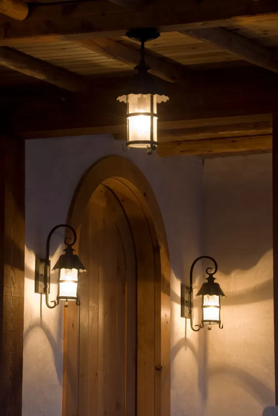 A doorway with two lanterns on the side of it