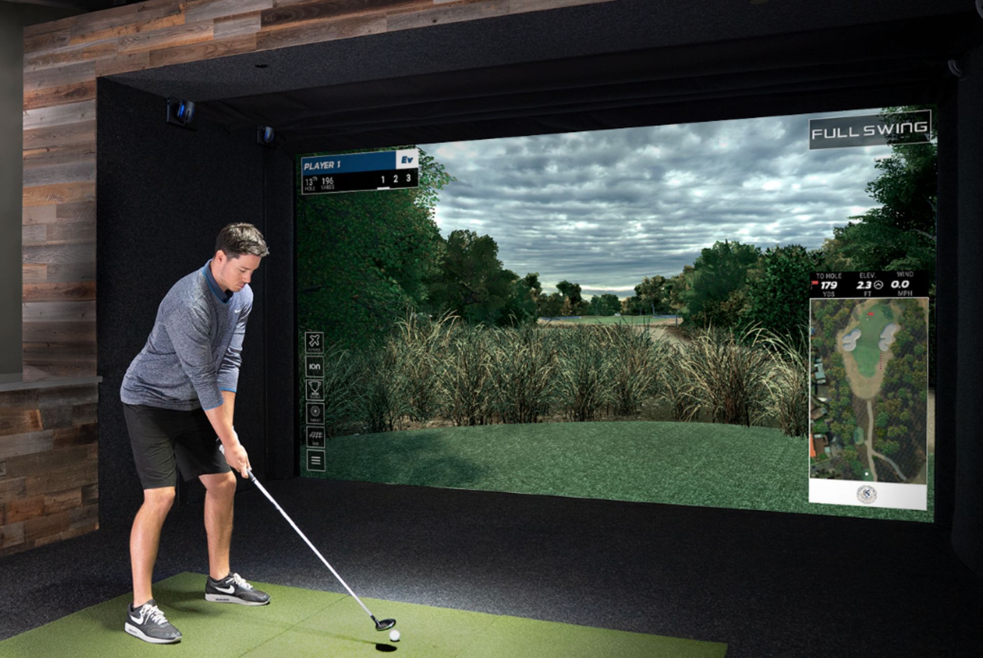 a man is playing golf in a full swing simulator