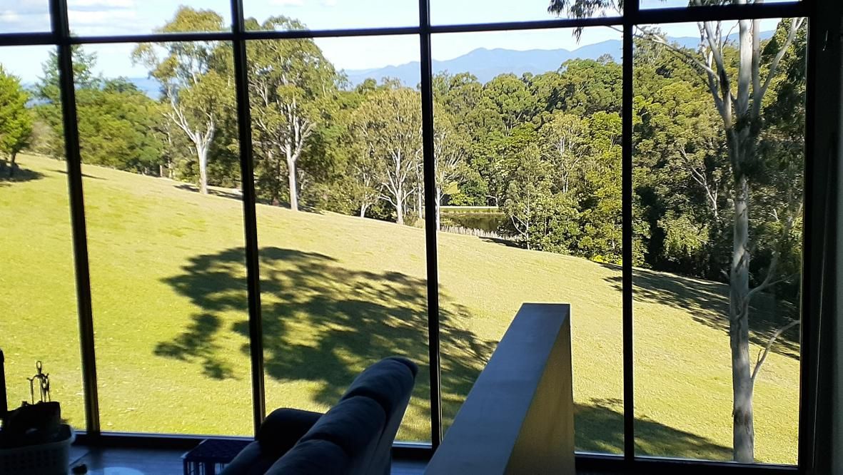 A Living Room with A View of A Field and Trees Through a Large Window — Nano2go in Birtinya, QLD
