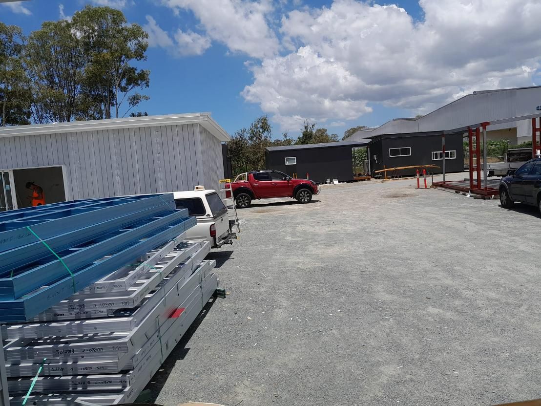 A Red Truck Is Parked Next to A Stack of Blue Ladders — Nano2go in Birtinya, QLD