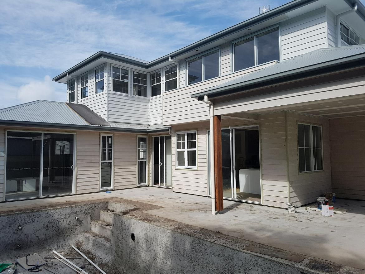 A Large House Is Being Built Next to A Swimming Pool — Nano2go in Birtinya, QLD