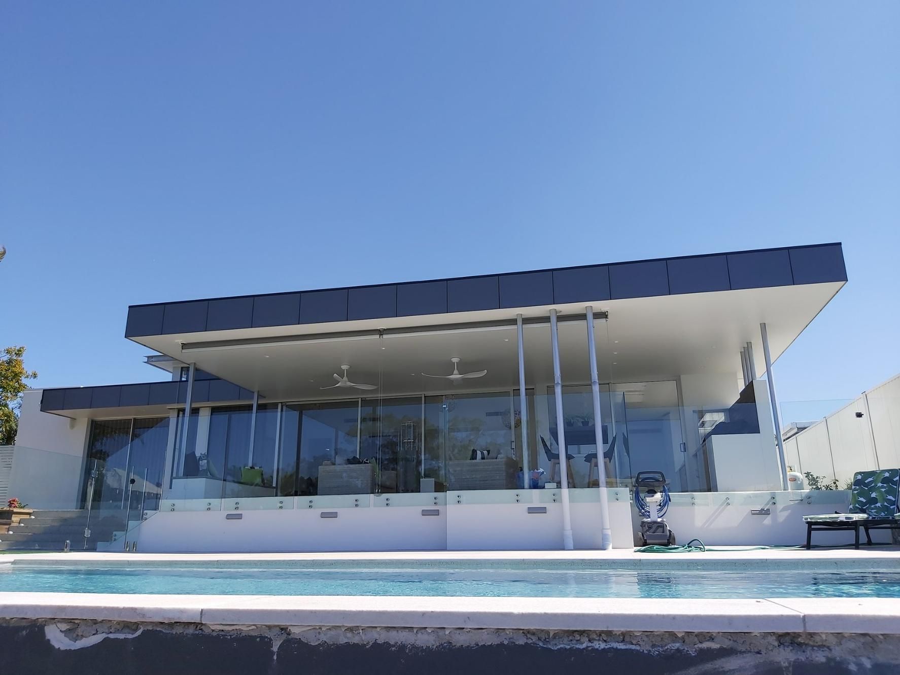 A Modern House with A Swimming Pool in Front of It — Nano2go in Birtinya, QLD