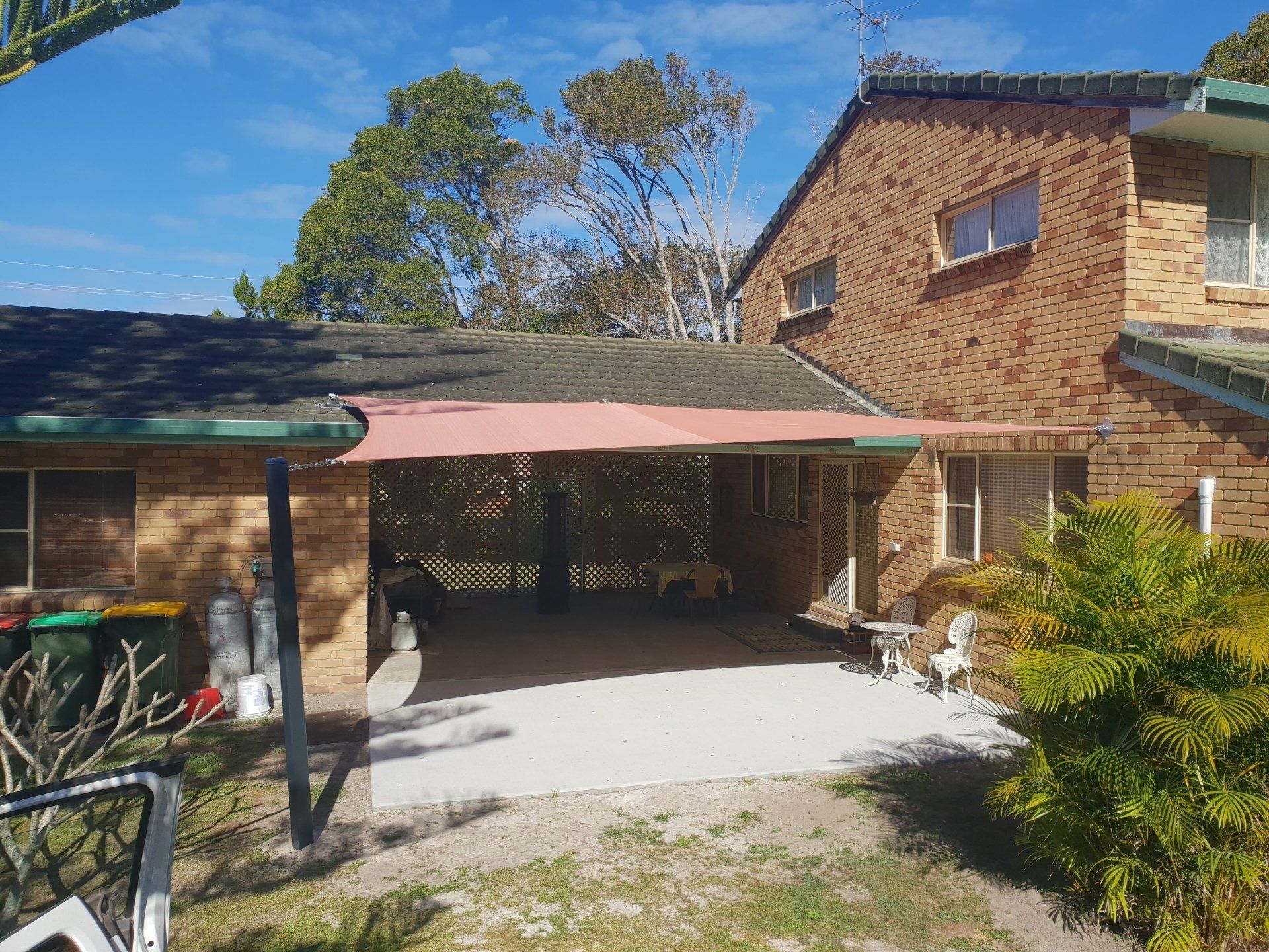 Red Shade Sail Over Concrete Patio-Smart Shades Lismore NSW