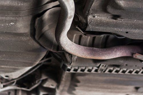 Close up Pipe Exhaust Rusty Iron Under Car — Corpus Christi, TX — Advantage Salvage & Auto Parts LLC