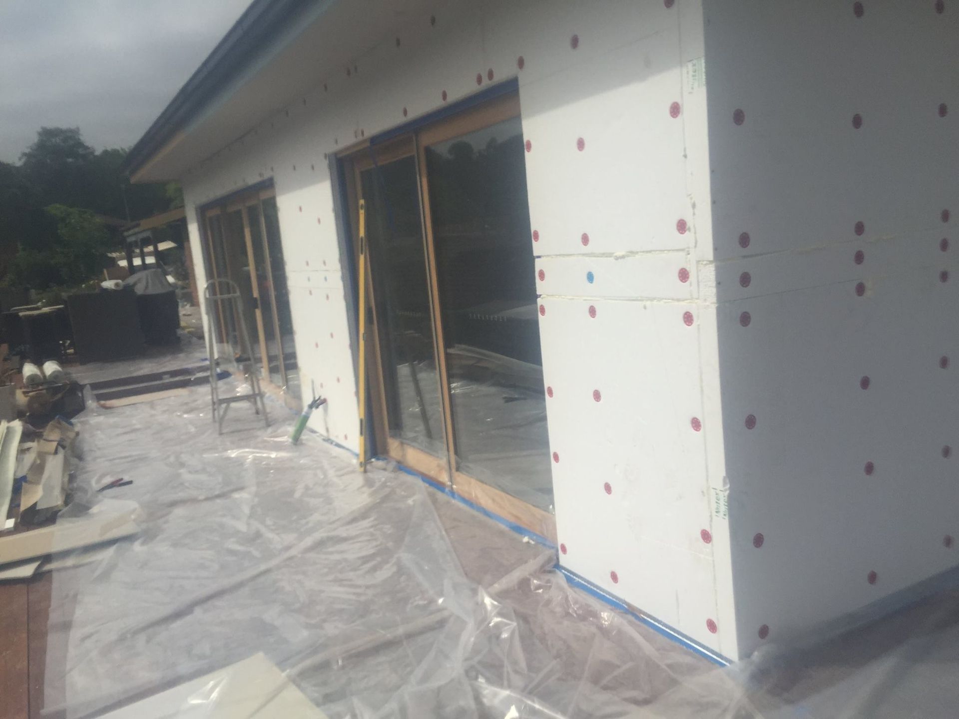 A House Is Being Built And Is Covered In Plastic – Dandenong, VIC - Pearl Rendering Services