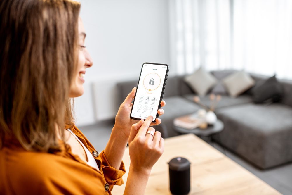 A woman is using a smart phone in a living room.