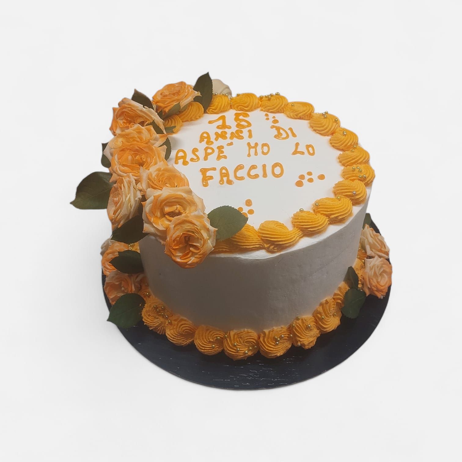 Cake decorated with orange frosting, flowers, and message 