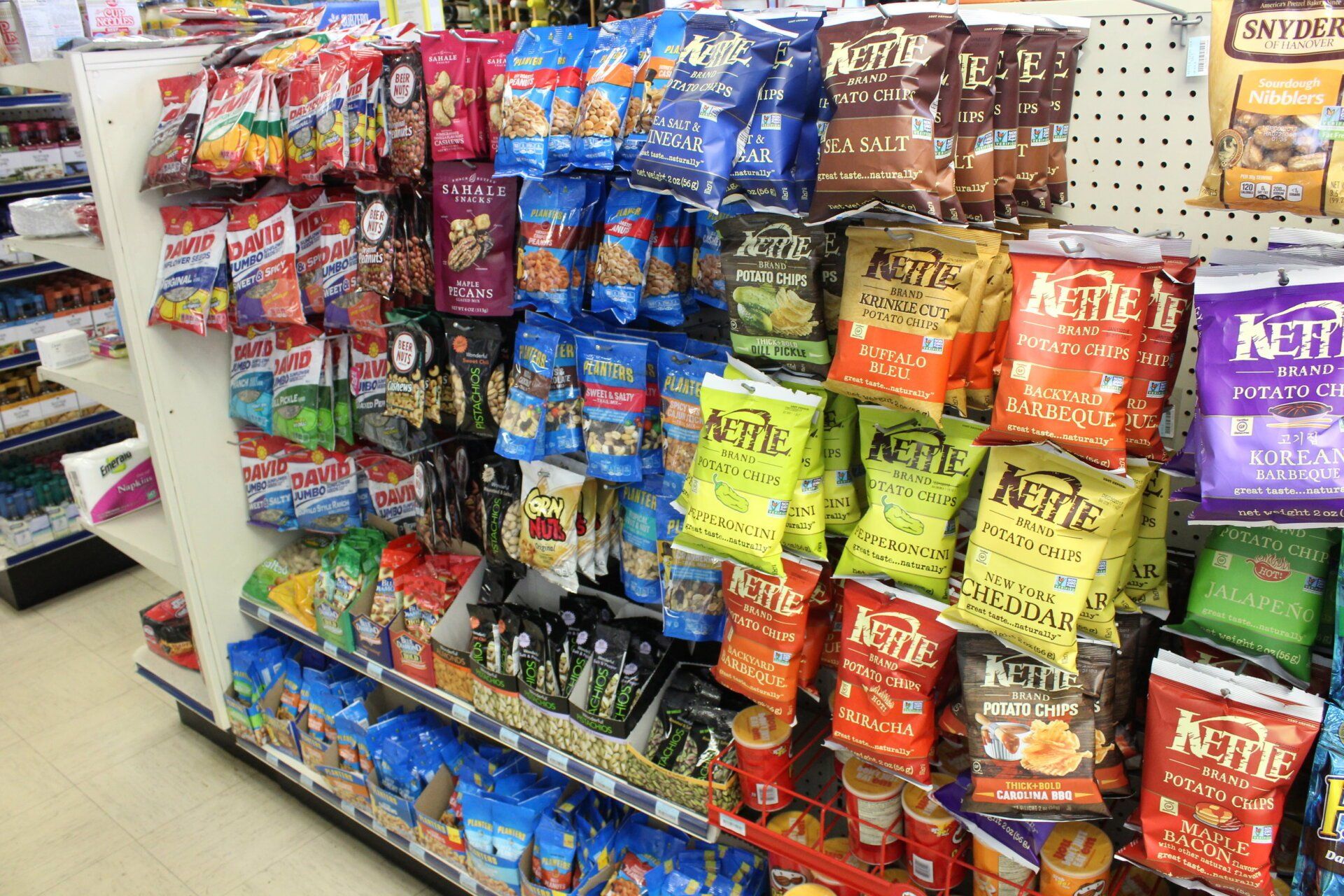 A grocery store aisle filled with lots of snacks.