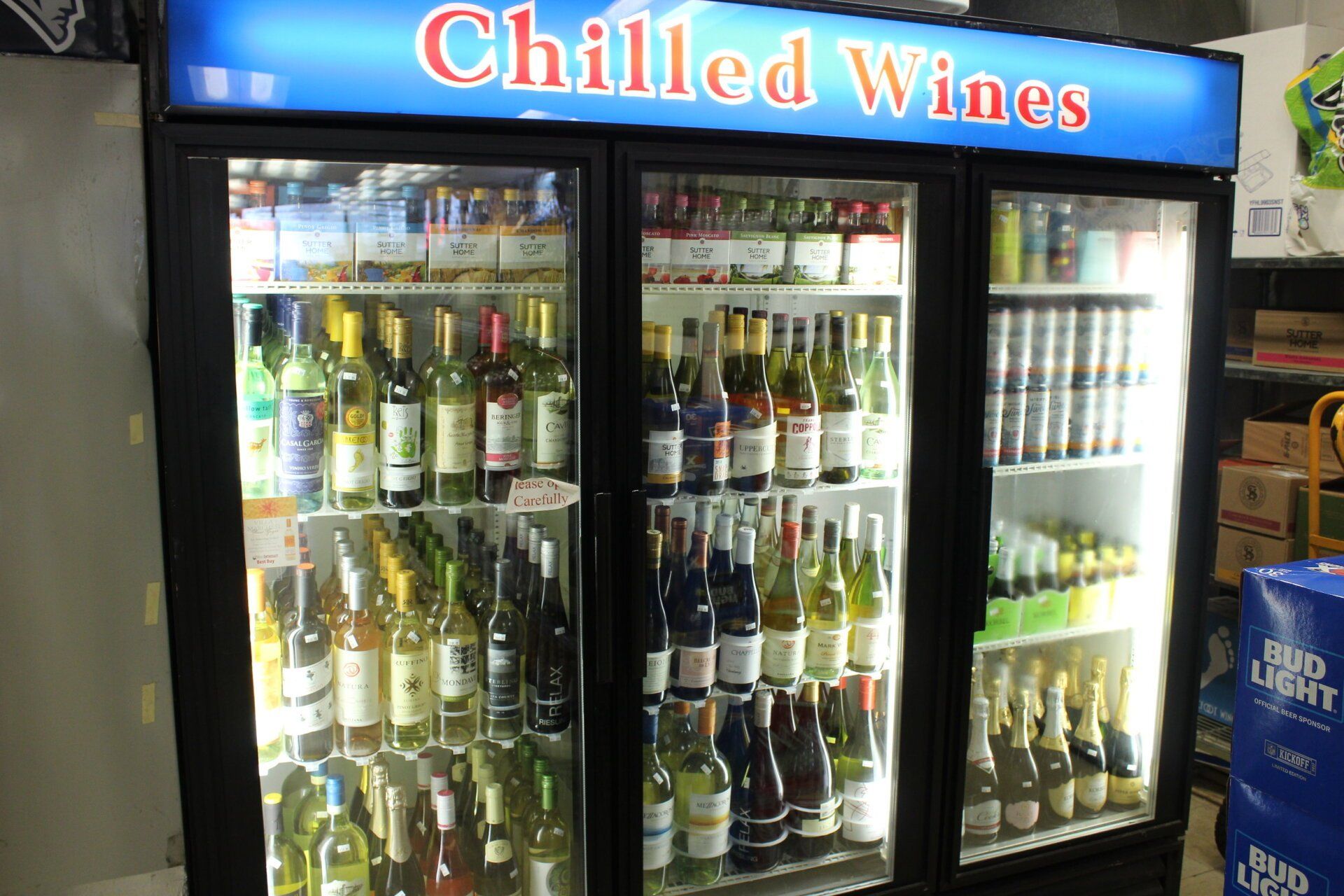 A refrigerator filled with bottles of chilled wines
