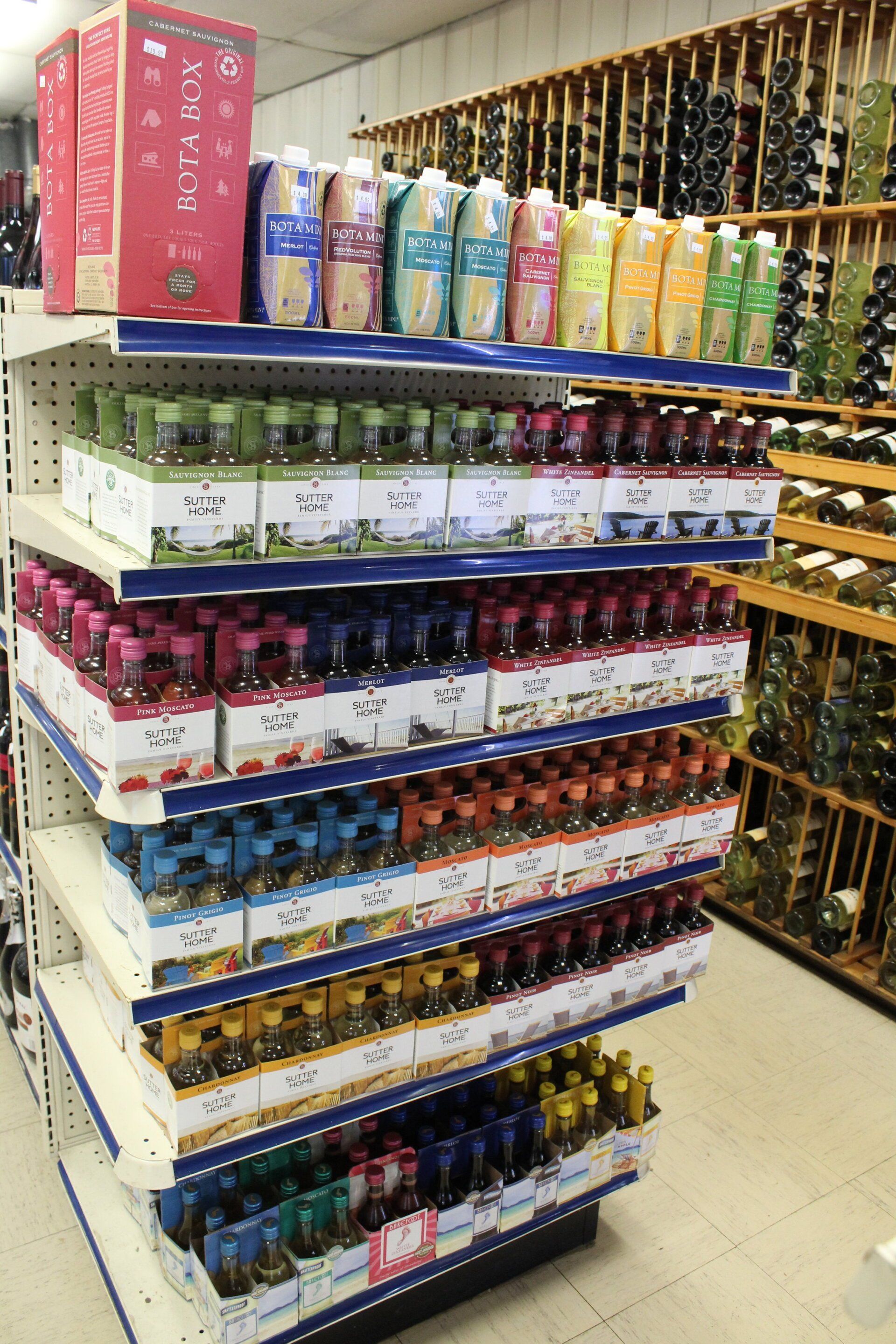 A store shelf filled with lots of different types of drinks.
