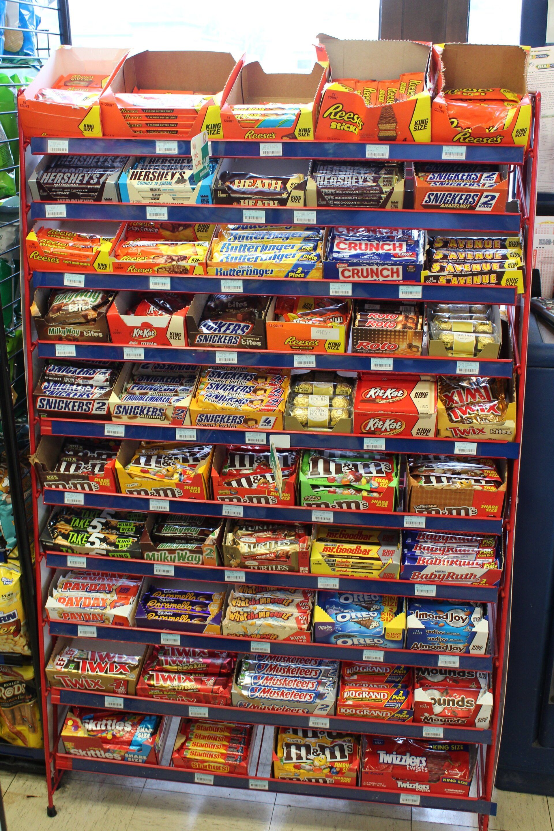 A store display of candy including reeses and m&m 's