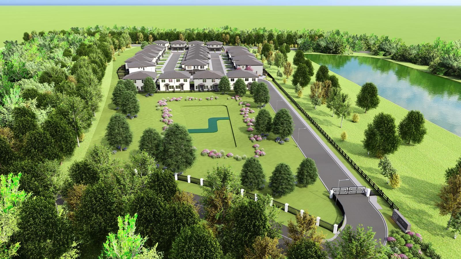 Aerial view of a senior living facility surrounded by trees, a pond, and a roadway.