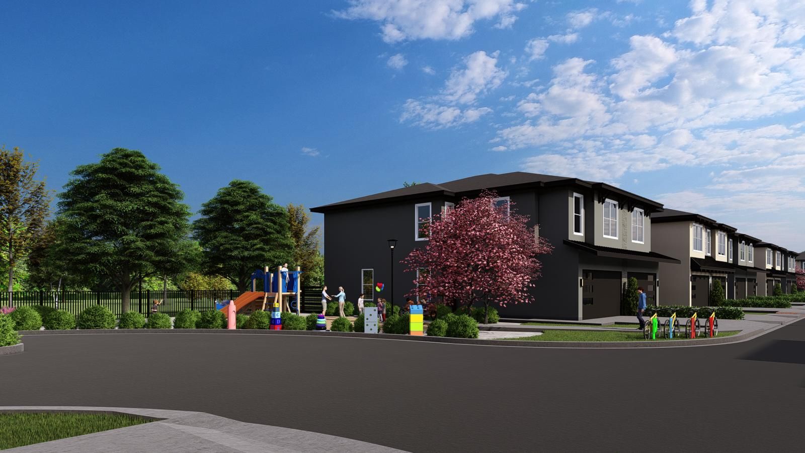 Row houses with playground, trees, and blue sky.