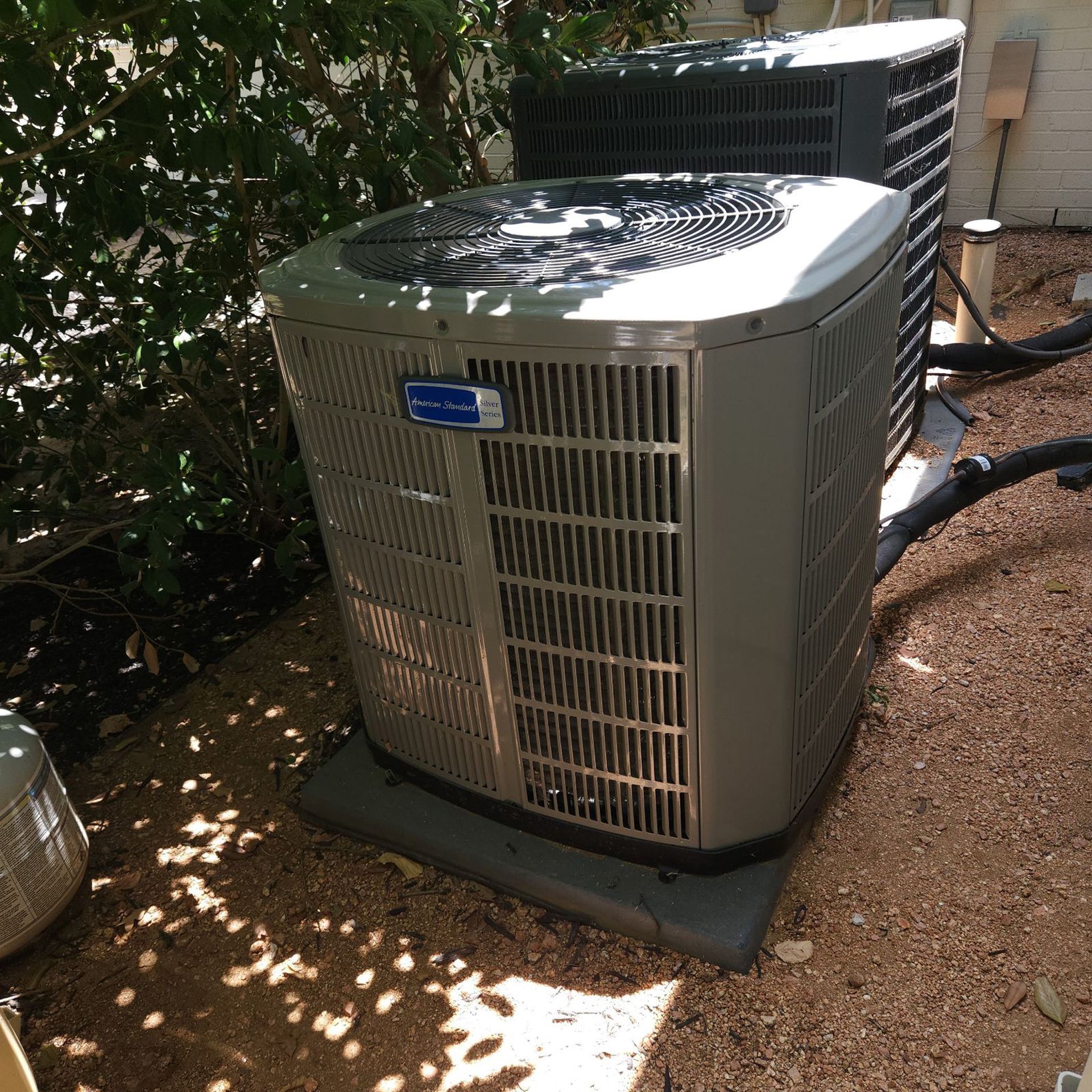 A gray air conditioner with the word carrier on it