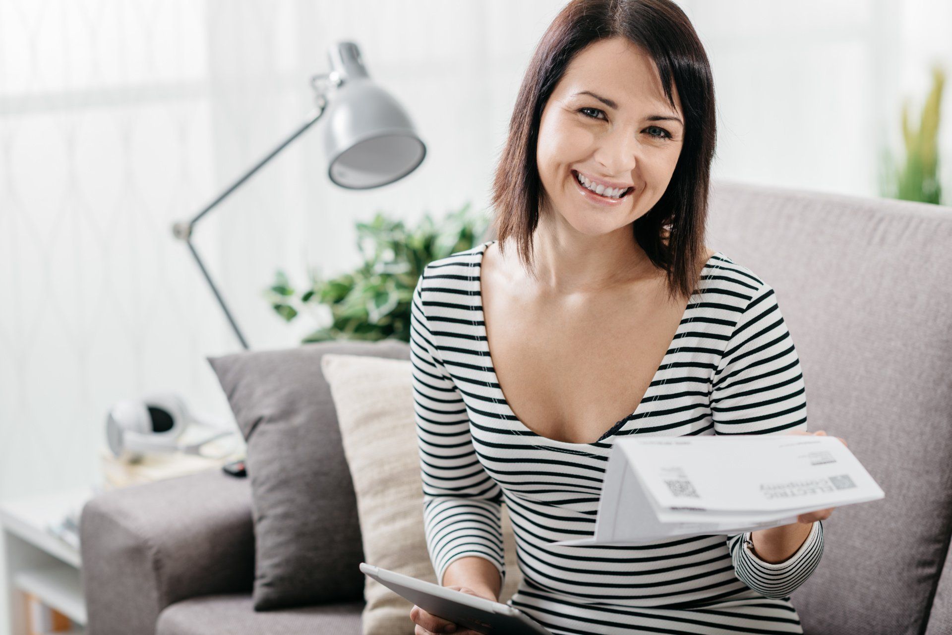 woman reading electric bill after getting solar power