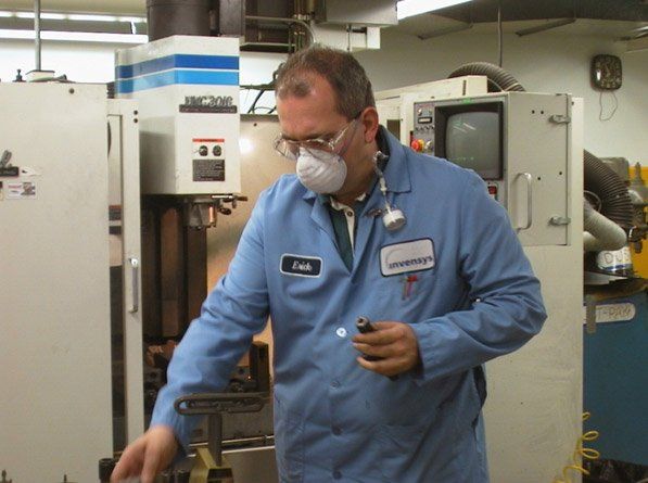 A man wearing a mask and a name tag that says chris