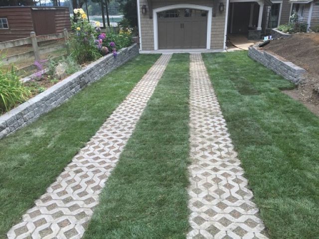 Pavers inset in lawn to drive on.  Grass driveway to the garage.