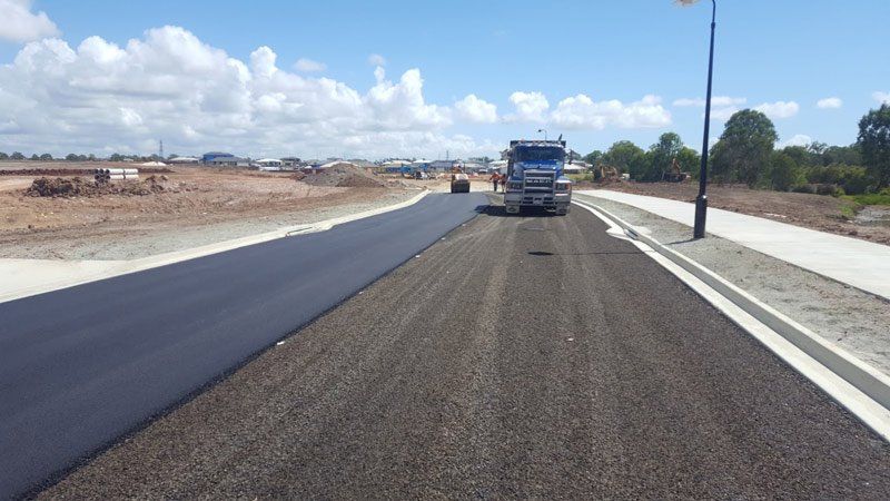 workers spraying road