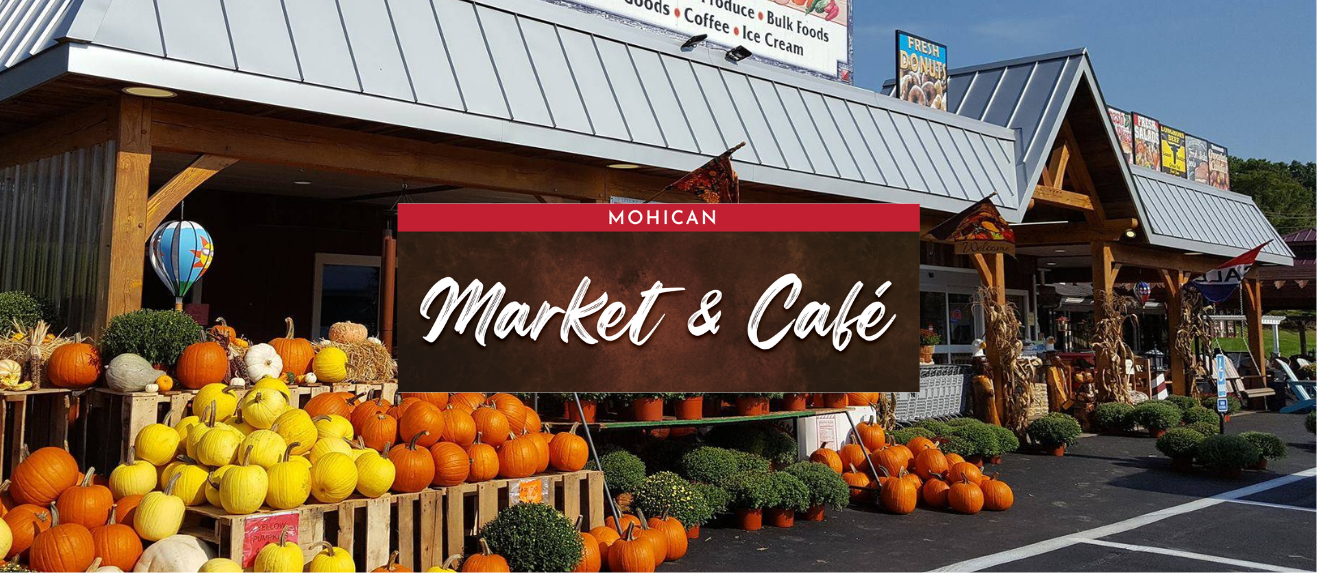 A market and cafe with pumpkins in front of it and the Mohican Country Market logo in the foreground. 