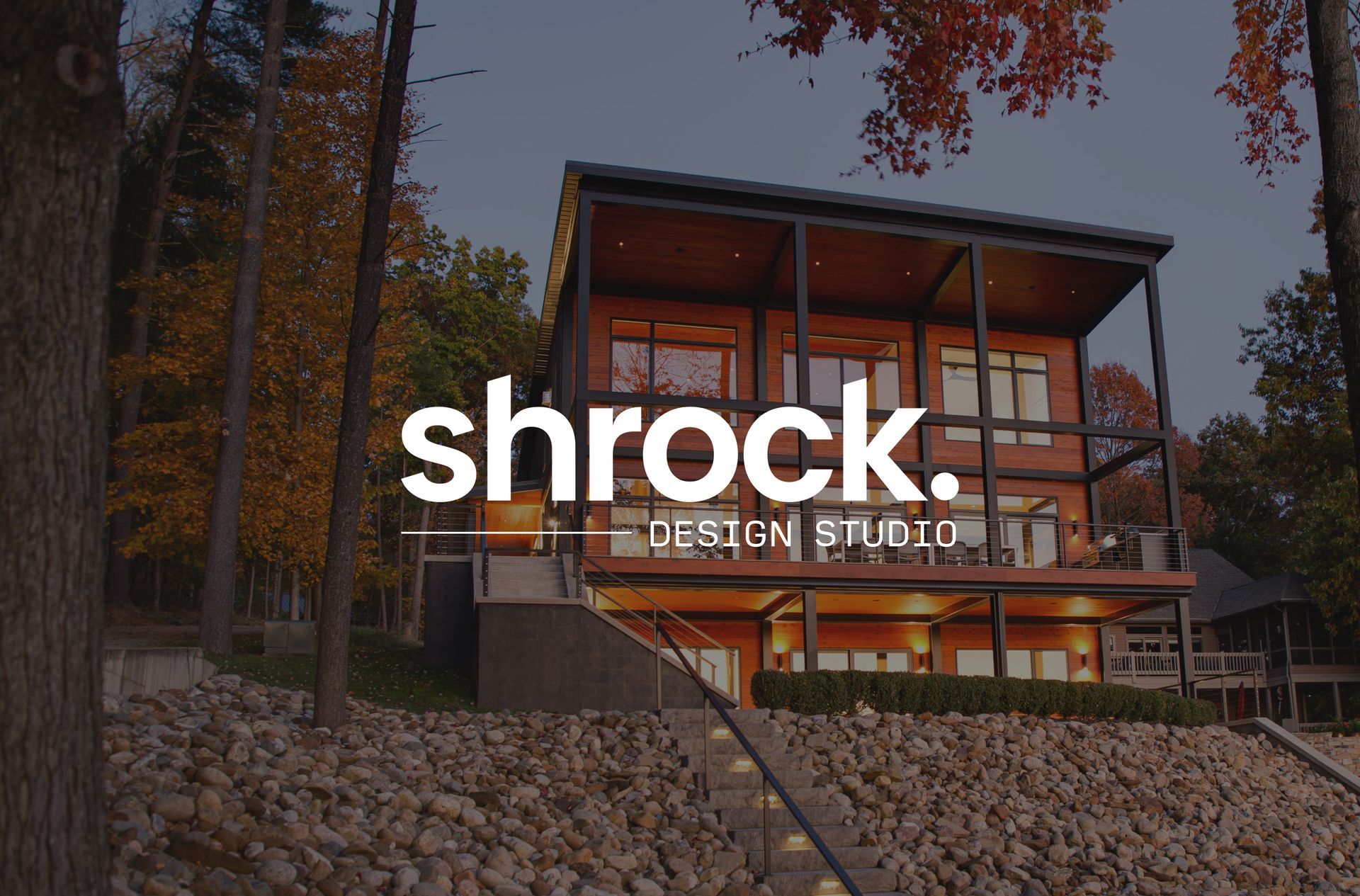 A picture of a custom home with the Shrock Design Studio logo in the foreground. 