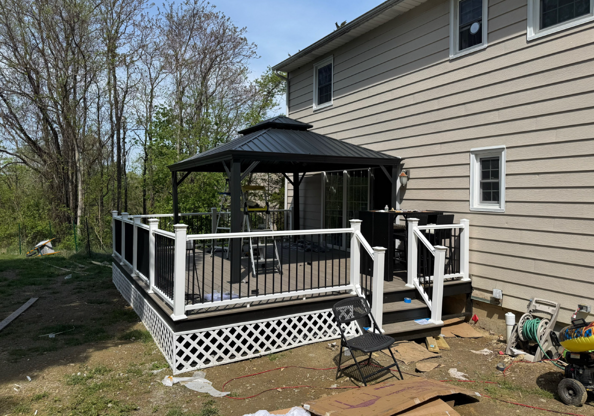 Person applying caulk from a tube to a seam where a wall meets a ceiling.