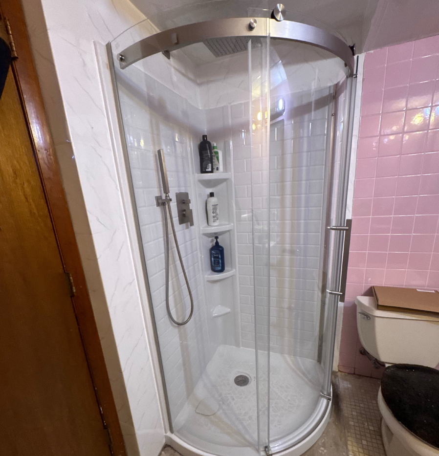 Modern bathroom with double sink, marble countertop, and towel display.