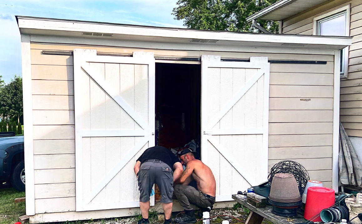 Person installing a door lock with a screwdriver, inside a house.