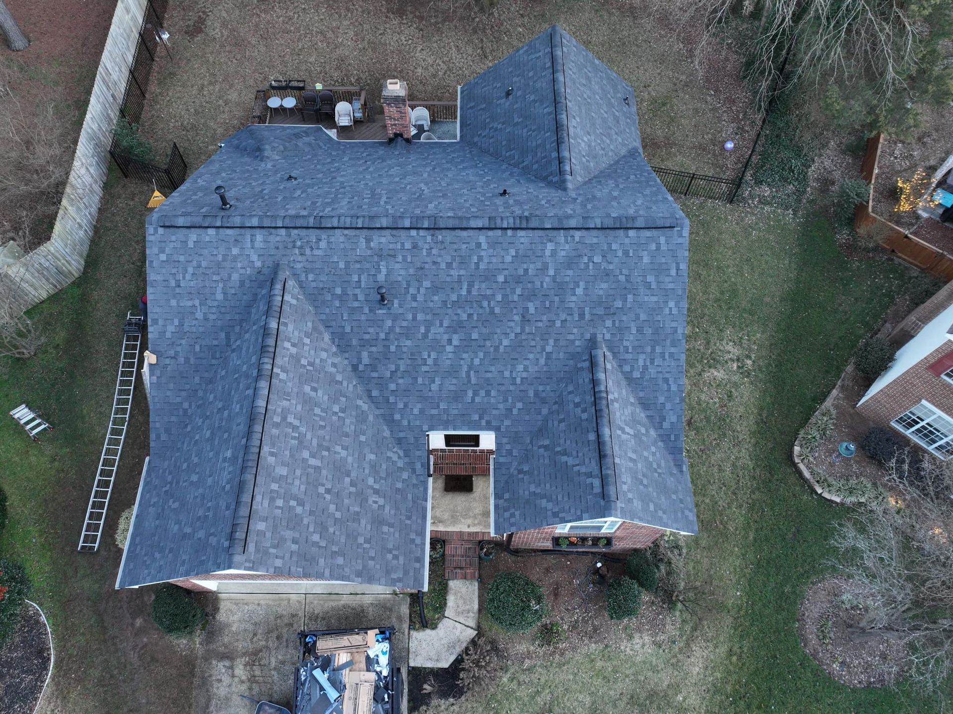 An aerial view of a house with a new roof.