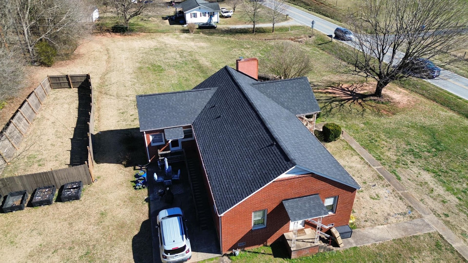 An aerial view of a house with a car parked in front of it.
