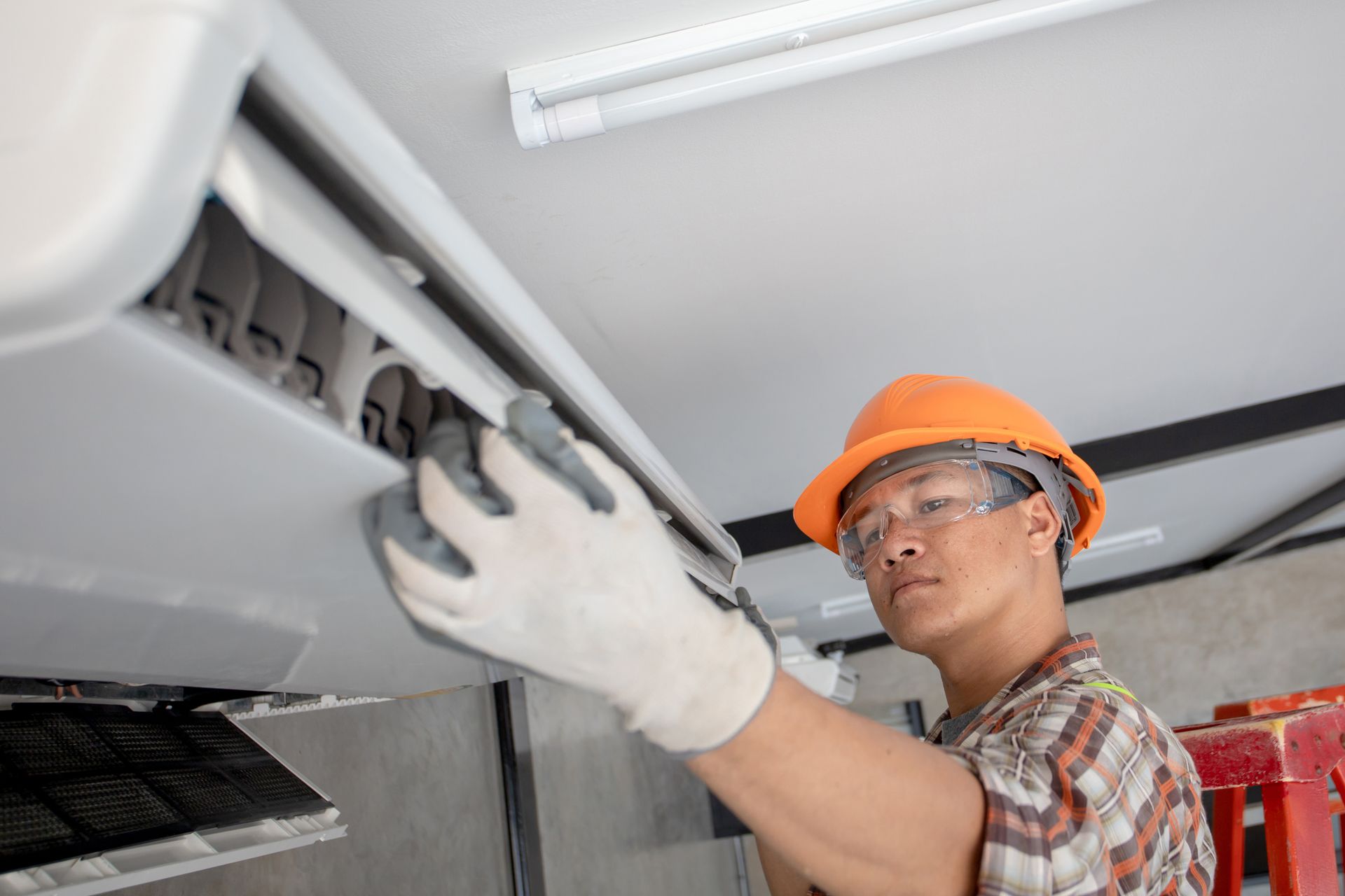 Air Conditioning Technician Repairing Air Conditioner and install new air conditioner
