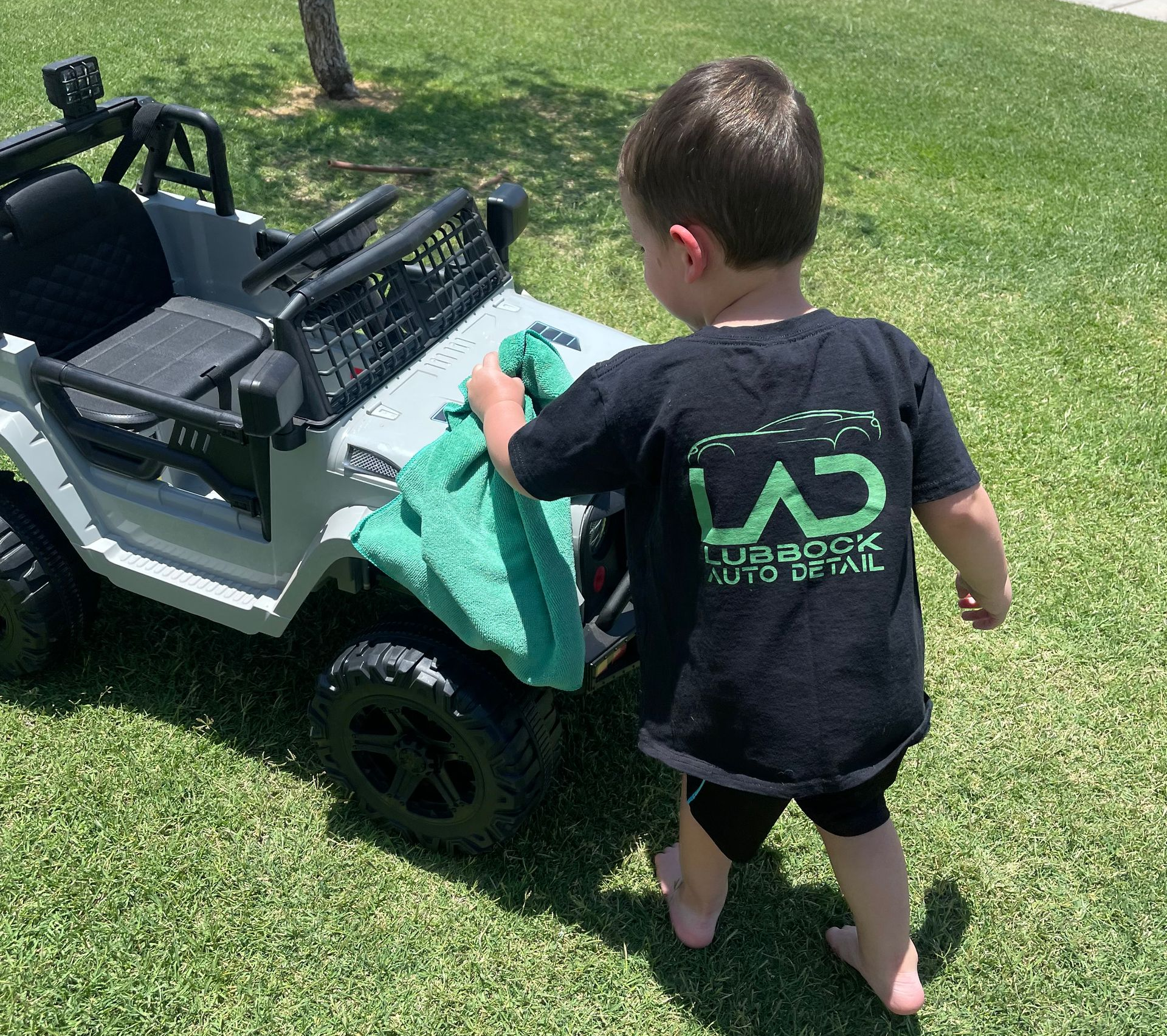 A blue car with flames painted on the hood is parked on the side of the road.