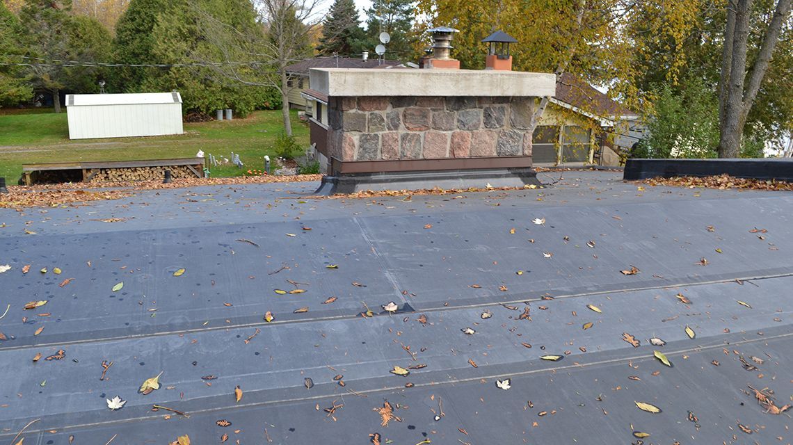 dark roof with a brick chimney in the center