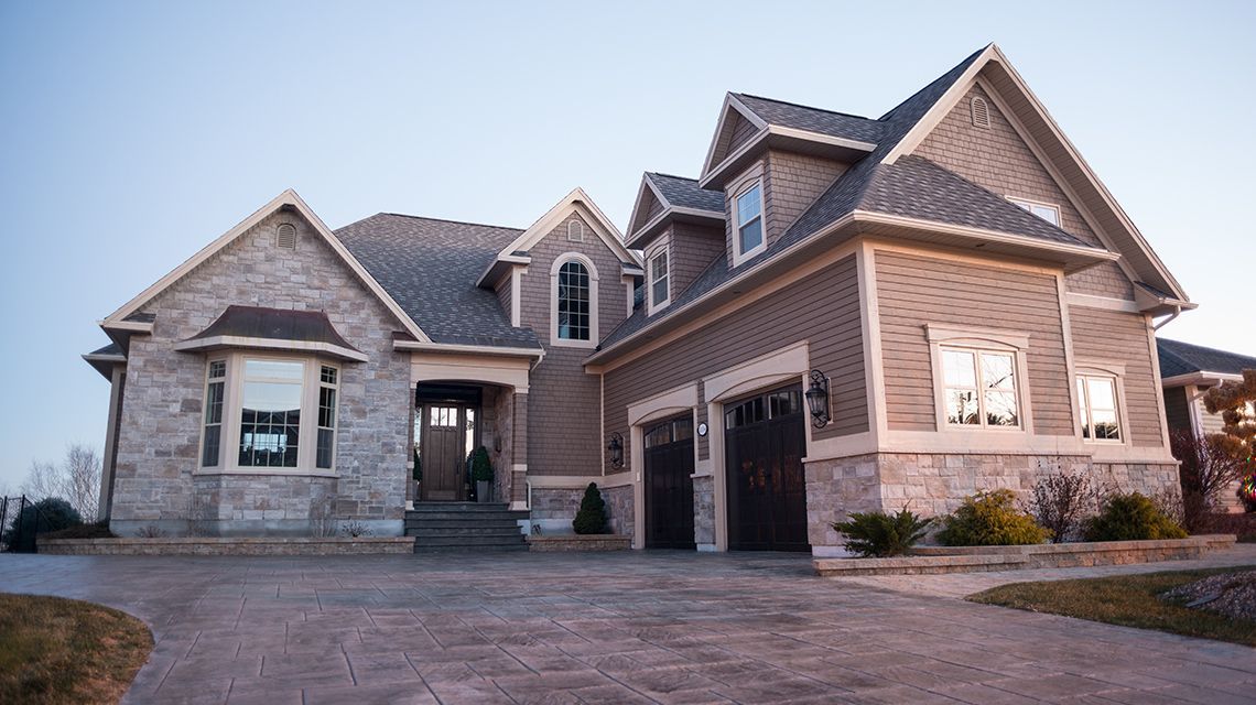 two-story house with stone and brown siding