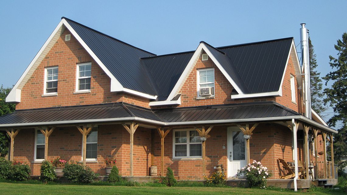 Brick house with black metal roof