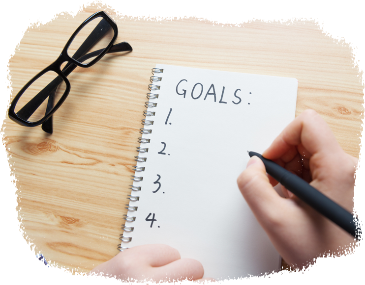 a list of goals being written on a notebook