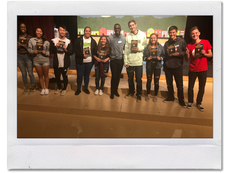 A row of graduates from Tony Shavers III personal development workshop holding Is Your Dream Really Worth It?