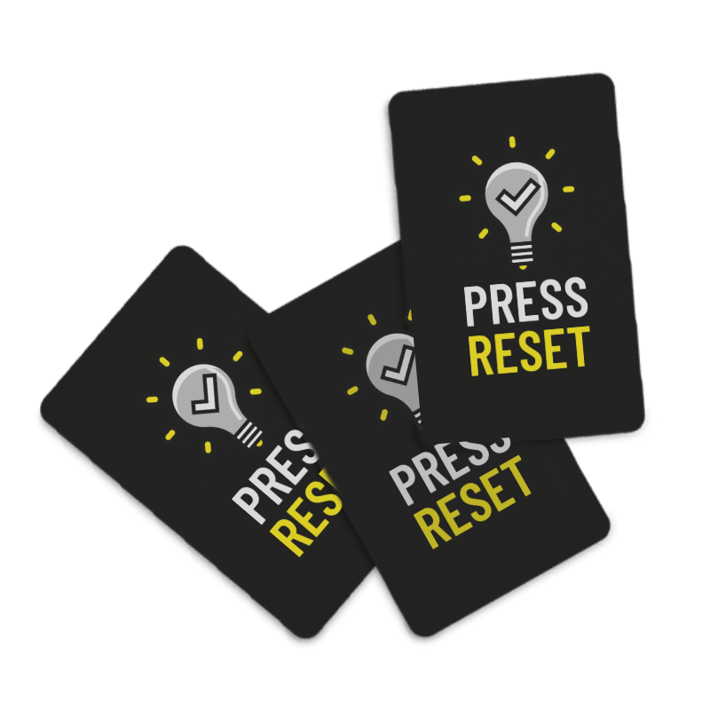 A scattering of three Press Reset positive affirmation cards