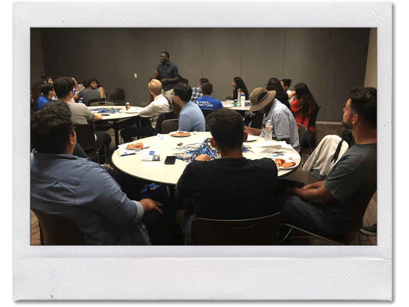 Personal Development Coach Tony Shavers III speaking to a conference room full of future entrepreneurs