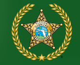 Flag of the Florida Sheriffs Association, green background with a gold star and wreath around a state emblem.