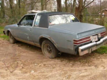 Picture of a grey junk car.